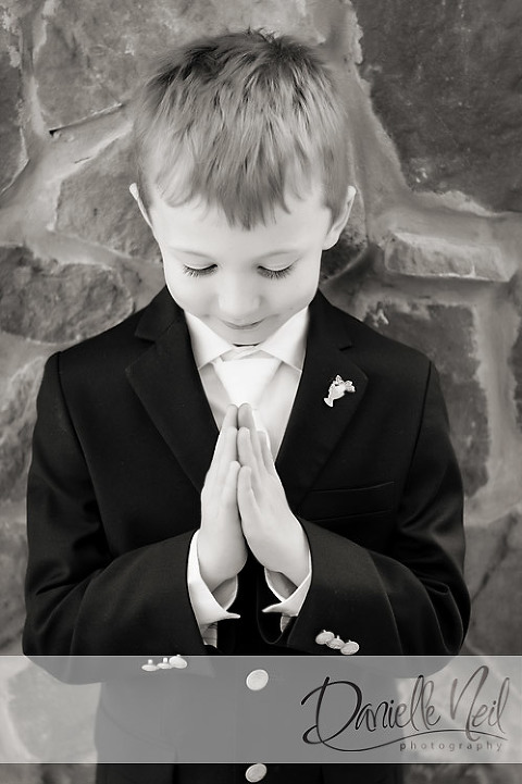 boy praying first communion photograph